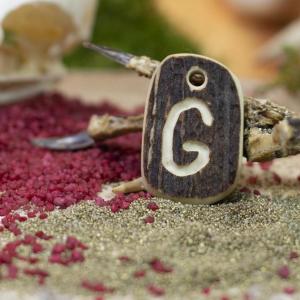Pendant "G" carved into deer antler